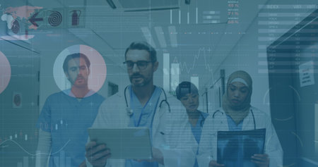 Image of graphs and data over diverse female and male doctors with x ray walking in hospital....