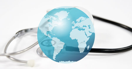Composite image of earth over close up of stethoscope against white background. world health day...