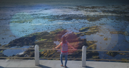 Image of light spots over biracial woman admiring view on promenade. health and fitness concept...