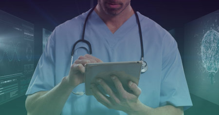 Image of caucasian male doctor with tablet over data processing. global medicine, finances, connections and digital interface concept digitally generated image.の写真素材