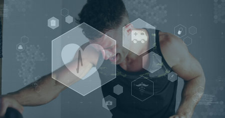 Image of medical and health icons over caucasian man exercising in gym. active healthy lifestyle and sports concept digitally generated image.の写真素材