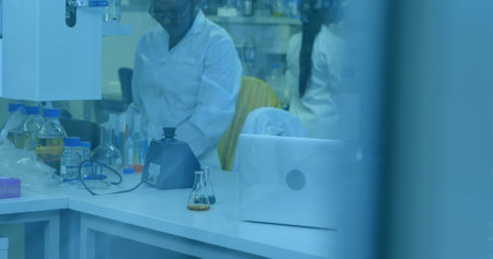 Mid adult lab technician is examining flask amid pipette racks in flat design, science theme....