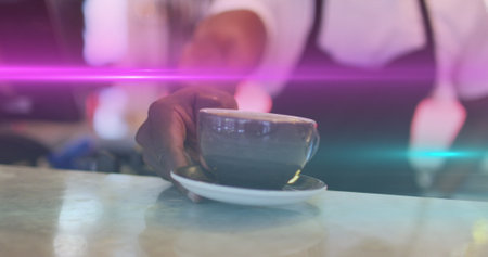 Image of light spots over biracial man serving coffee in cafe. global business and digital interface concept digitally generated image.の写真素材