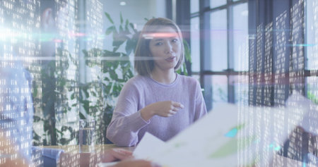 Image of diverse business people talking over data processing. global business, finances, connections and digital interface concept digitally generated image.の写真素材