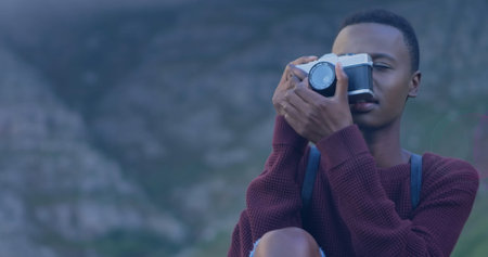 Spot of light against african american female photographer clicking pictures with digital camera. world photo day awareness conceptの写真素材