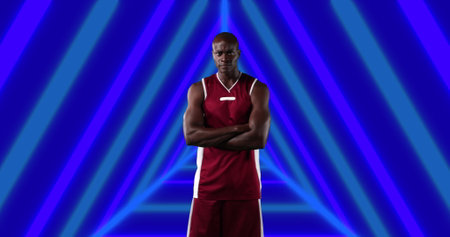 Image of african american male basketball player with arms crossed over shapes. global sport and...