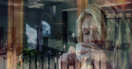 Image of financial data processing and statistics over caucasian woman drinking coffee. global business, finance and data processing concept digitally generated image.の写真素材