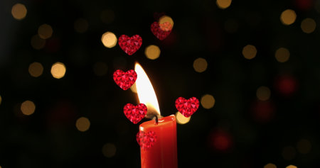 Image of hearts over spots and candle. new year's eve party celebrations concept digitally generated image.の写真素材