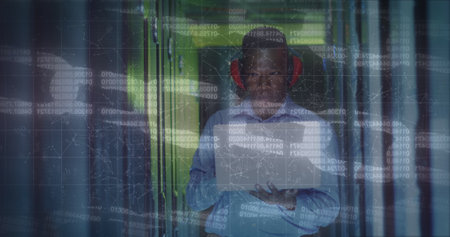 Image of data processing over african american male worker in server room. global technology and...
