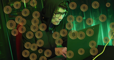 Image of bitcoins over asian male hacker in server room. global technology and digital interface...