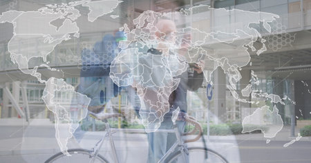 Image of world map and caucasian male doctor over caucasian man with bicycle. global business and digital interface concept digitally generated image.の写真素材