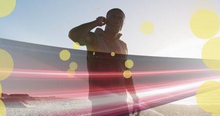 Image of spots over african american man with earphones at beach. health and fitness concept...