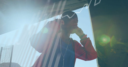 Statistical data processing against african american fit man wearing earphones outdoors. sports and...