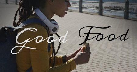 Image of good food text over biracial woman sitting and eating on promenade. health and fitness...