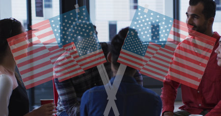 Image of american flags over diverse business people talking. global business and digital interface...