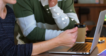 Image of media icon over caucasian businesswoman using laptop. Business technology and teamwork concept.の写真素材