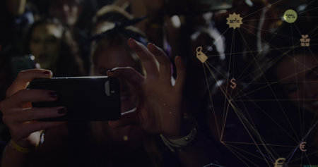 Image of connections of with icons over hands of diverse people on concert. music, entertainment,...