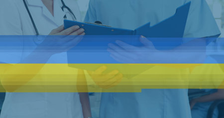 Image of flag of european union over surgeon in operating theatre. Business finance and networking concept digitally generated image.の写真素材