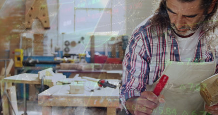 Image of data processing over caucasian male carpenter working in workshop. Global communication, work and digital interface concept digitally generated image.の写真素材