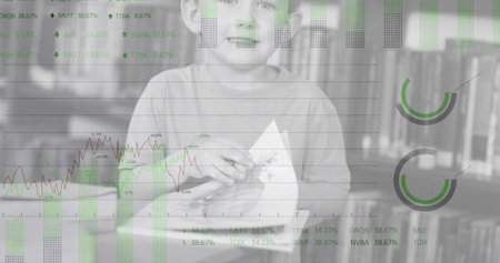 Image of financial data processing over reading caucasian boy. Global business, finances, data processing and digital interface concept digitally generated image.の写真素材