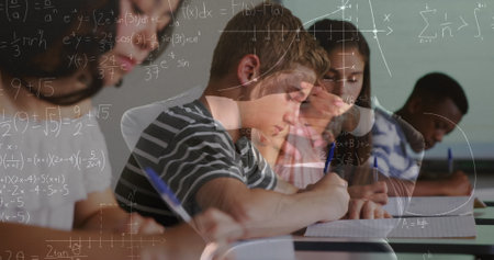 Image of math formulas moving over class of diverse pupils learning at school. learning, school, education and technology concept digitally generated image.の写真素材