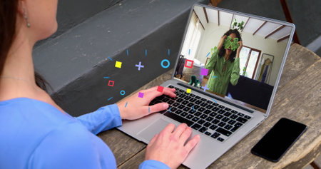 Image of media icons over caucasian woman having image call with colleague. Global business and...