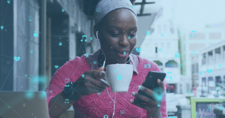 Image of network of connections with social media icons over woman using laptop. social media and...