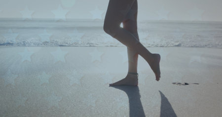 Low section of woman walking on the beach. Travel and vacation conceptの写真素材
