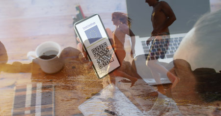 Image of caucasian woman with smartphone over caucasian women at beach. Global business and digital interface concept digitally generated image.の写真素材