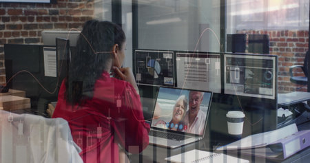 Image of financial graphs over woman having image call in office. Business, communication and...