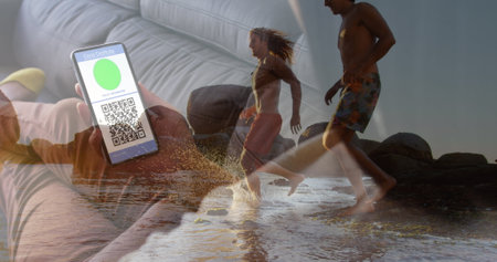 Image of woman with covid passport on smartphone over happy diverse friends on beach. Holidays, vacations and travel during covid 19 pandemic concept digitally generated image.の写真素材