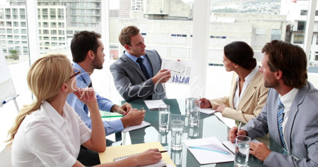 Image of heart day over caucasian businesspeople working in office. Business, working in office and celebration concept digitally generated image.の写真素材