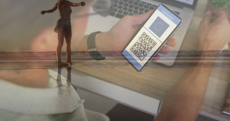 Image of man with covid passport on smartphone over happy caucasian woman on beach. Holidays, vacations and travel during covid 19 pandemic concept digitally generated image.の写真素材