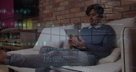 Image of data processing over businessman using tablet. Global business and digital interface...