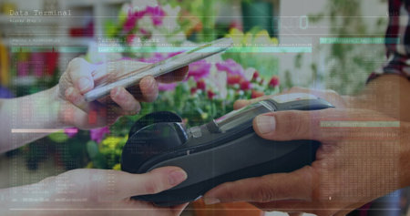 Image of financial data over hands of diverse people using payment terminal. Business, trade, finance and contactless payments concept digitally generated image.の写真素材