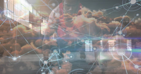Network of digital icons over clouds in the sky against african american fit man performing push ups. Global networking and sports technology conceptの写真素材