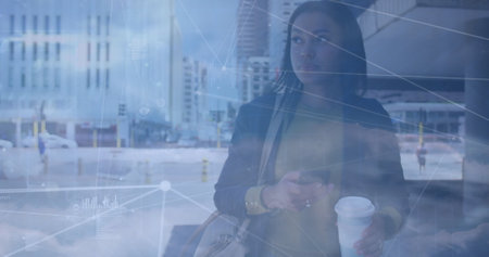 Image of network of connections against african american businesswoman using smartphone. Global...