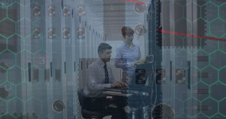 Microprocessor connections over caucasian male and female engineers working at server room. Business...