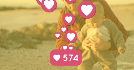 Image of falling hearts over happy caucasian happy baby with dad. National learning and development...