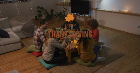 Image of happy thanksgiving day text over happy diverse friends eating. Thanksgiving day, celebration and digital interface concept digitally generated image.の写真素材