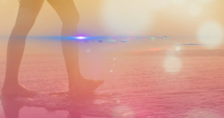 Image of light spots over caucasian woman at beach. Global business and digital interface concept digitally generated image.の写真素材