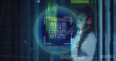 Image of data processing over african american female server room worker using headphones. Cloud computing concept digitally generated image.の写真素材