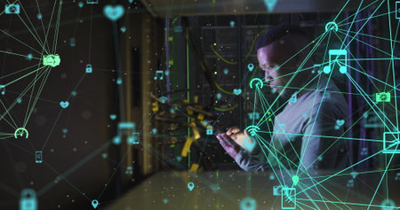Image of network of connections with icons over african american male server room using tablet....