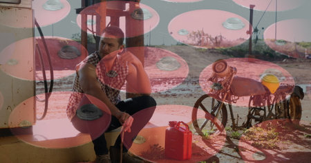 Image of barrels over caucasian man at petrol station. National petroleum day and digital interface concept digitally generated image.の写真素材