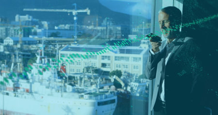 Image of data processing over caucasian businessman talking on smartphone. Global business, computing and digital interface concept digitally generated image.の写真素材