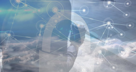Image of network of connections over clouds and midsection of africanamerican businessman. Business,...
