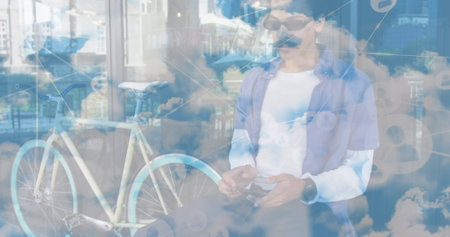 Image of network of connections and sky with clouds over african american man using smartphone. Global connections, sport and digital interface concept digitally generated image.の写真素材