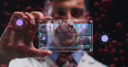 Image of purple virus cells over caucasian male doctor with digital card with virus data. Health, medicine, biology, science and covid 19 pandemic concept digitally generated image.の写真素材