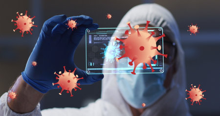 Image of orange virus cells over caucasian male lab worker in safety clothes with digital card. Health, medicine, biology, science and covid 19 pandemic concept digitally generated image.の写真素材
