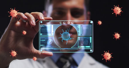 Image of orange virus cells over caucasian male lab worker with digital card with virus data. Science, medicine and covid 19 pandemic concept digitally generated image.の写真素材